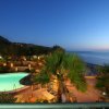 Piscina e palme al tramonto.