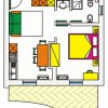 Piantina di un appartamento bilocale con cucina, zona pranzo, camera da letto e bagno.