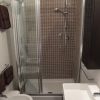 Bagno con doccia in vetro, lavandino e bidet.